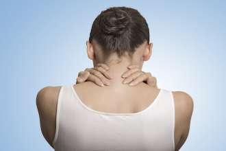 back view tired female massaging her painful neck