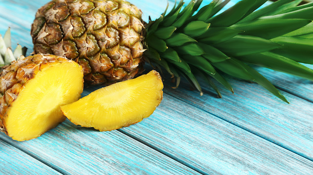 Ripe pineapples on a blue wooden background