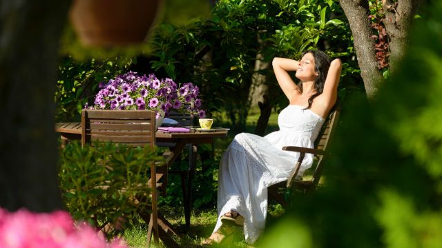 Woman resting in garden on summer