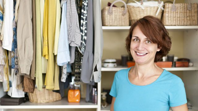 Smiling woman near closet