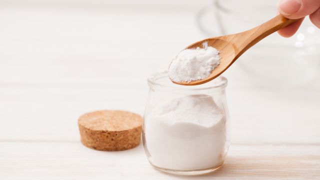 sea salt, starch in the jar and wooden spoon for recipes of cosmetics at home on a white wooden background
