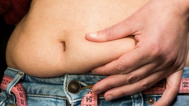 Woman showing fat belly