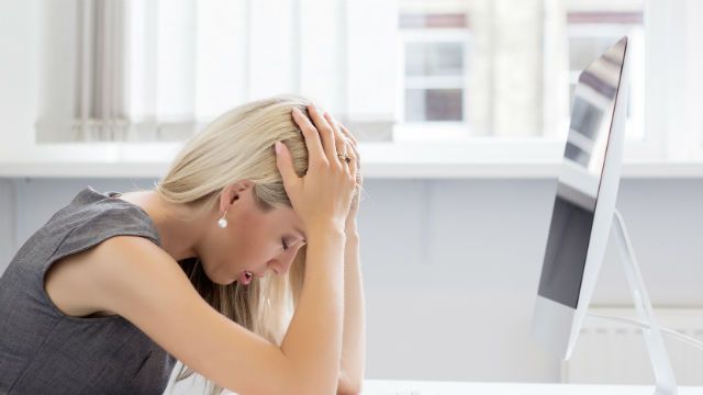 Overworked and tired young woman in front of computer