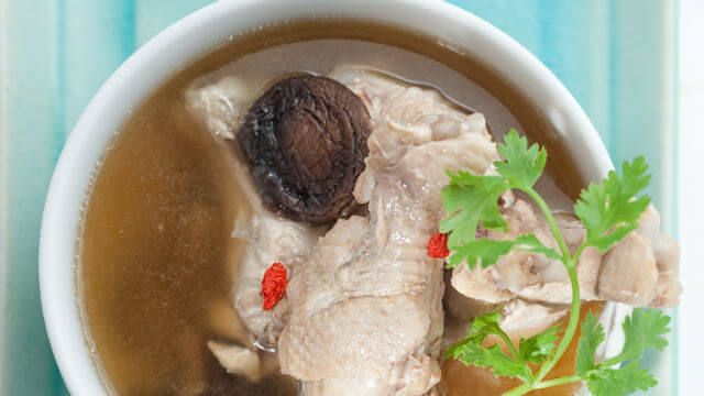 Traditional oriental chicken broth with mushrooms