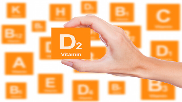 Hand holds a box of vitamin D2