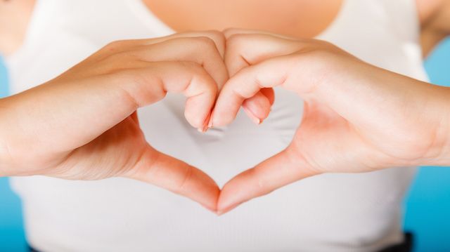 Girl hands with heart sign.