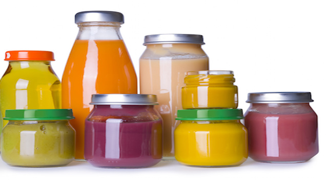 Composition of baby food jars and juice bottles on white