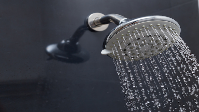 shower head with water drops flowing