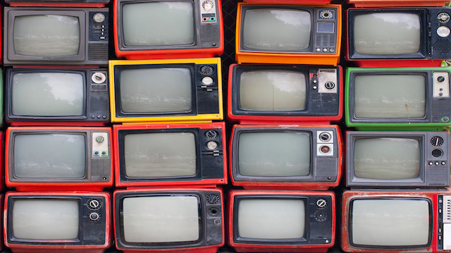 A wall of old vintage tube televisions