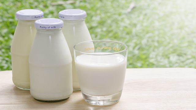 Bottles of fresh milk on table