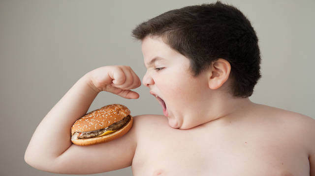 fat boy wants to eat   burger that lies on   biceps