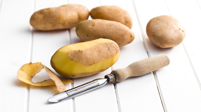 wooden peeler and potatoes