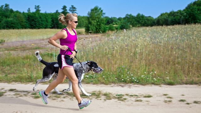woman-runner-with-a-dog-enjoying-her-workout