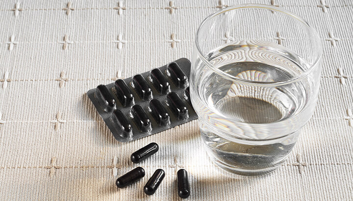 Mix activated charcoal with water to form a paste for your teeth