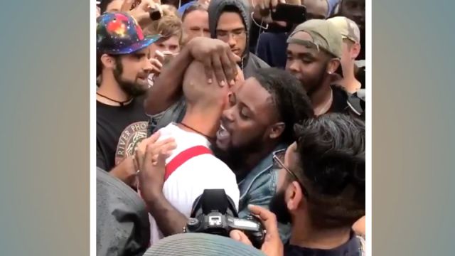 Protestor hugs Nazi