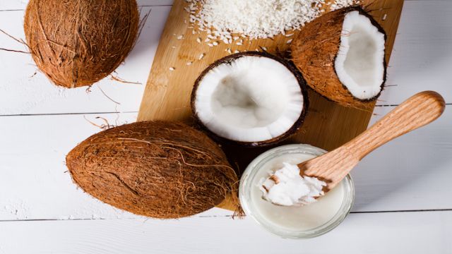 Whole and broken coconut with grated cocont flakes and coconut oil or butter.