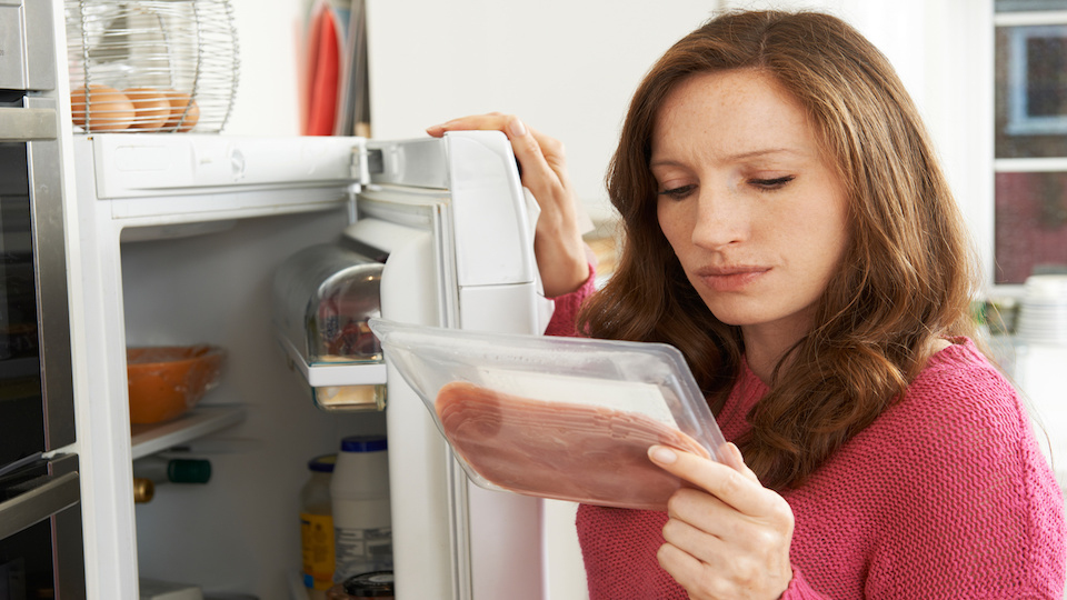 concerned-woman-looking-at-pre-packaged-meat-the-alternative-daily