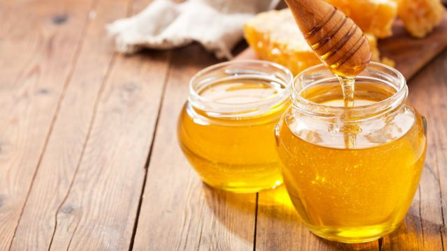 jar of honey with honeycombs