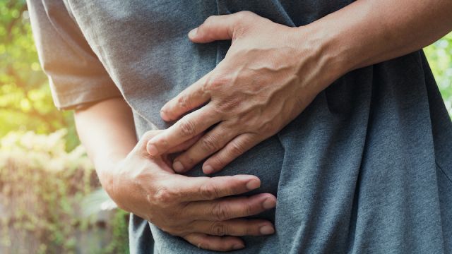 Male suffering from stomachache pain,A man stomachache at outdoor,Healthy concept.