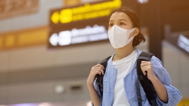 Asian travelers girl with medical face mask to protection the coronavirus in airport