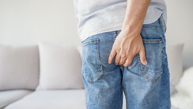 Young man has pain in the butt, Hemorrhoids, Anal disorders.
