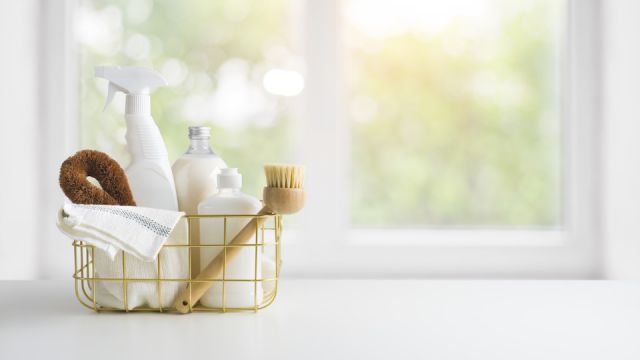 Eco-friendly natural cleaning products on table and window background