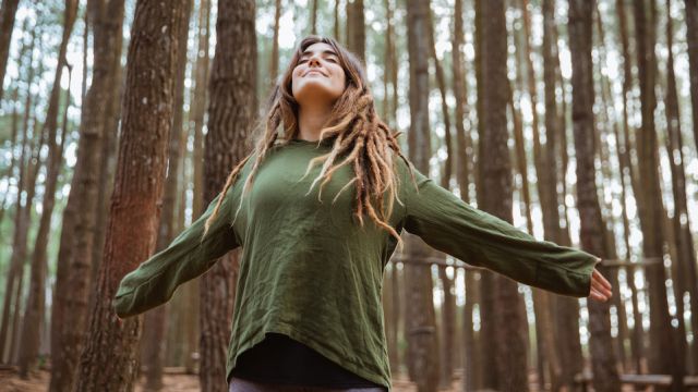 young woman hiker relaxing in the woods