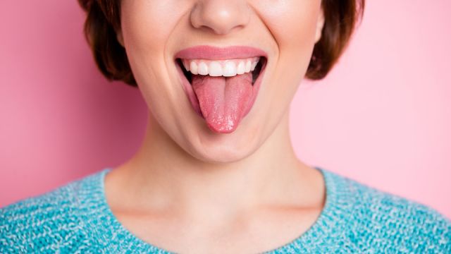 Cropped close-up view portrait of her she nice attractive crazy cheerful cheery woman showing tongue grimacing healthy oral cavity isolated over pink pastel color background
