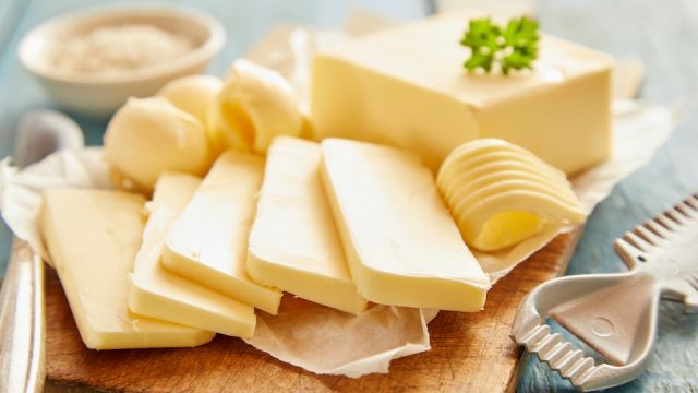 Close up view of butter sliced on cutting board