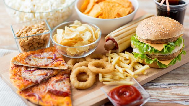 close up of fast food snacks and drink on table