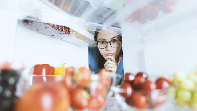 Woman taking healthy food from the fridge