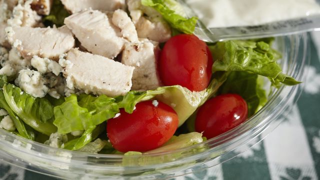 Pre-made salad in a plastic container. A staple food of the modern world.