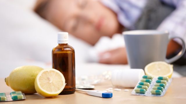 Vitamins medicines for flu woman in background