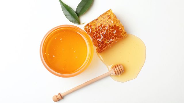 Composition with fresh honey on white background, top view