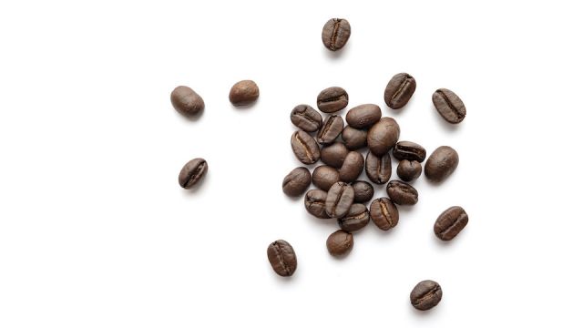 Coffee beans isolated on white background. Close-up.